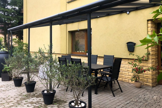 Aluminium patio cover with outdoor dining set and potted plants, Kings Awning product example