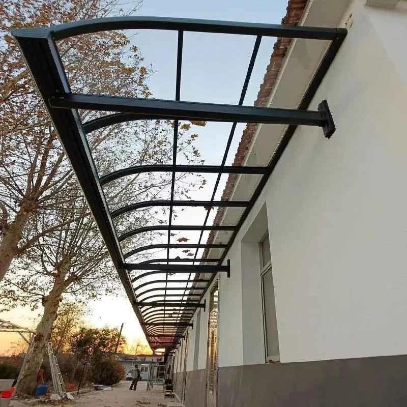 Solid polycarbonate retractable canopy awning installed above windows on a white building exterior
