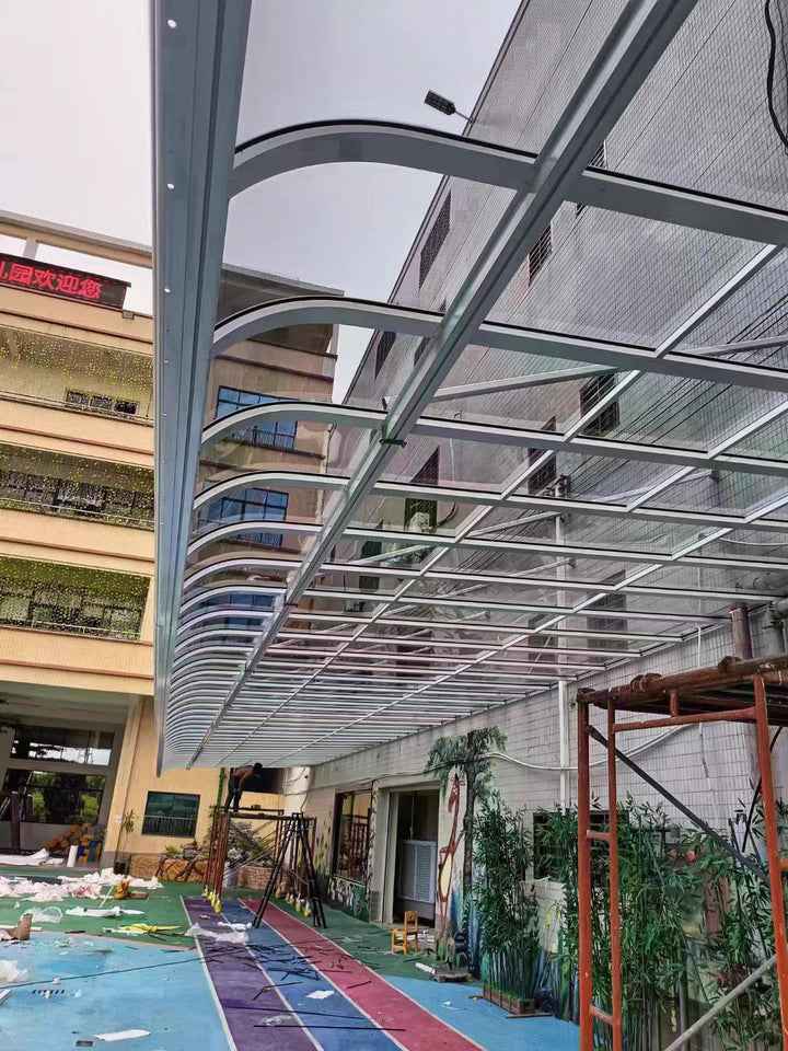 Large custom metal awning installed beside a building, demonstrating outdoor shade structure by Kings Awning.
