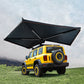 Yellow SUV with large rooftop awning on grassy field, Kings Awning outdoor shade solution