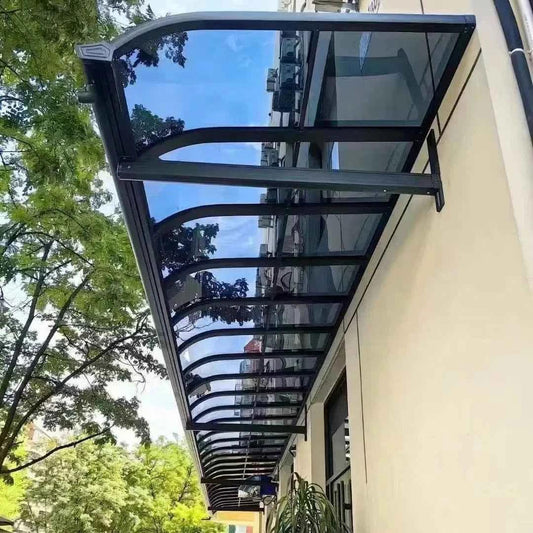 Heavy-duty polycarbonate outdoor awning installed above windows on modern home exterior
