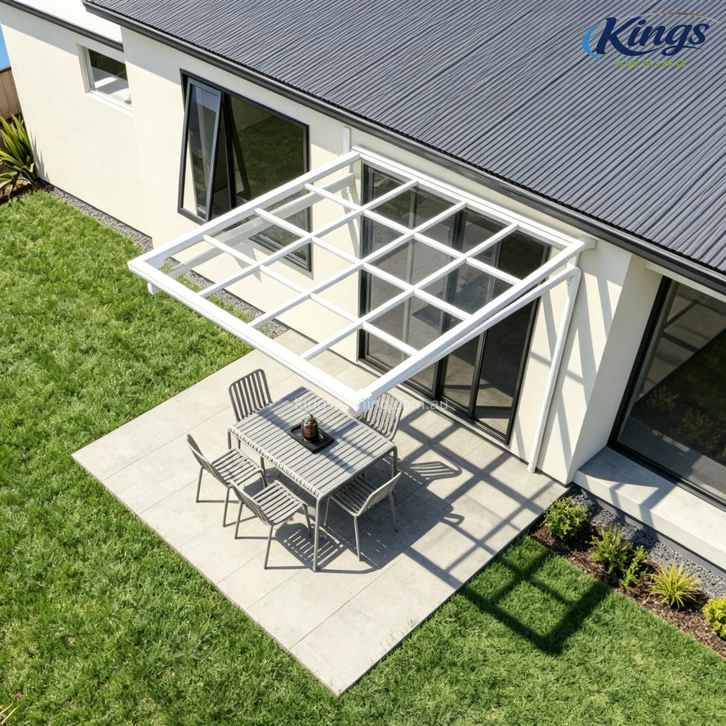 White awning with outdoor dining area and garden