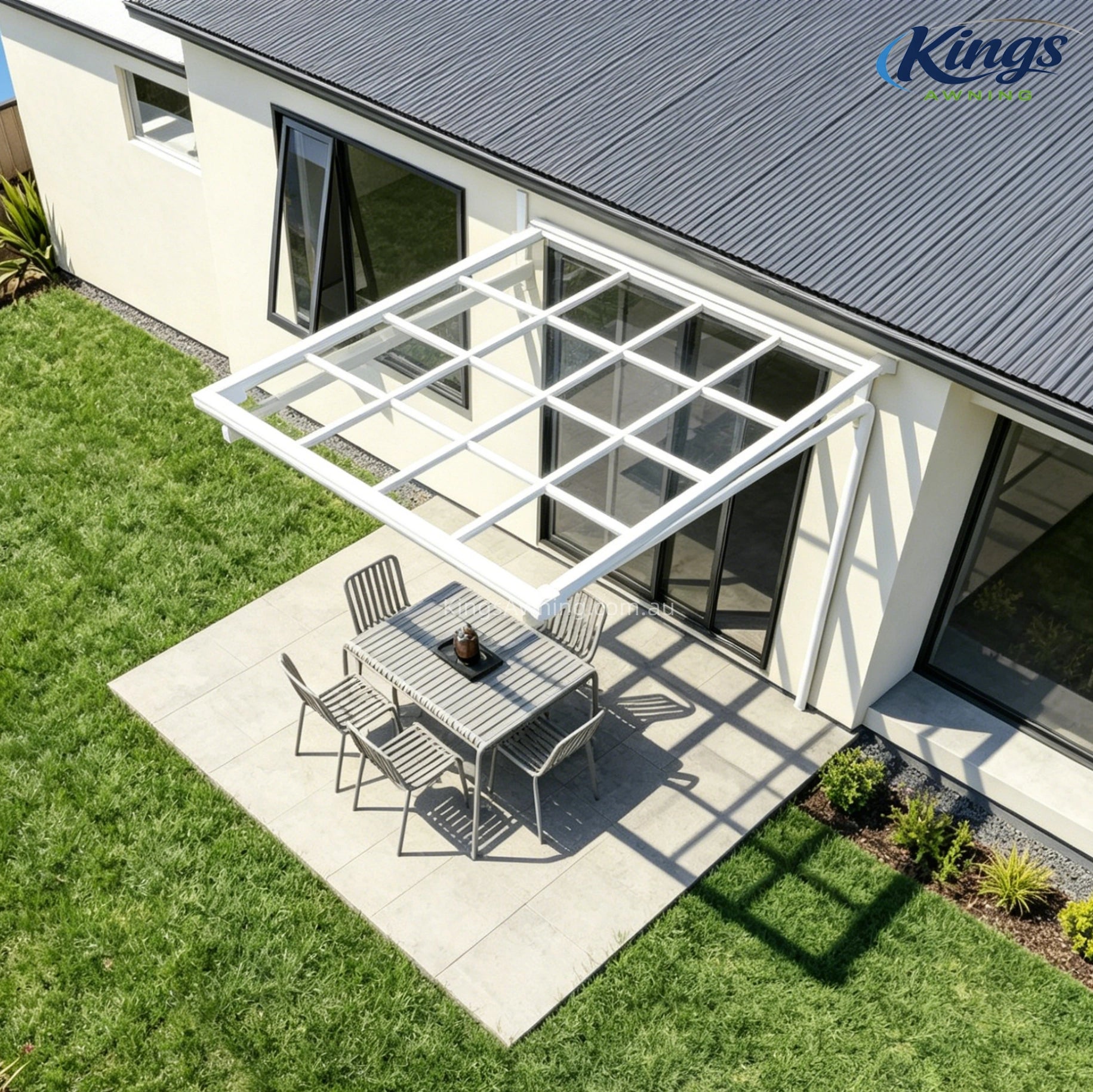 White awning with outdoor dining area and garden
