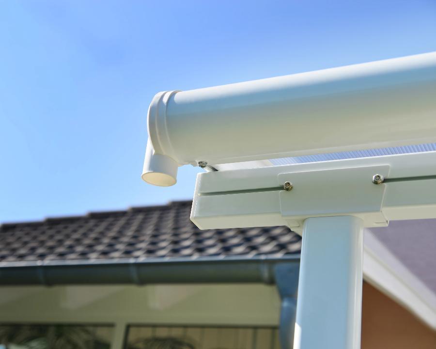 White patio cover gutter system close-up, outdoor awning by Kings Awning in sunny backyard